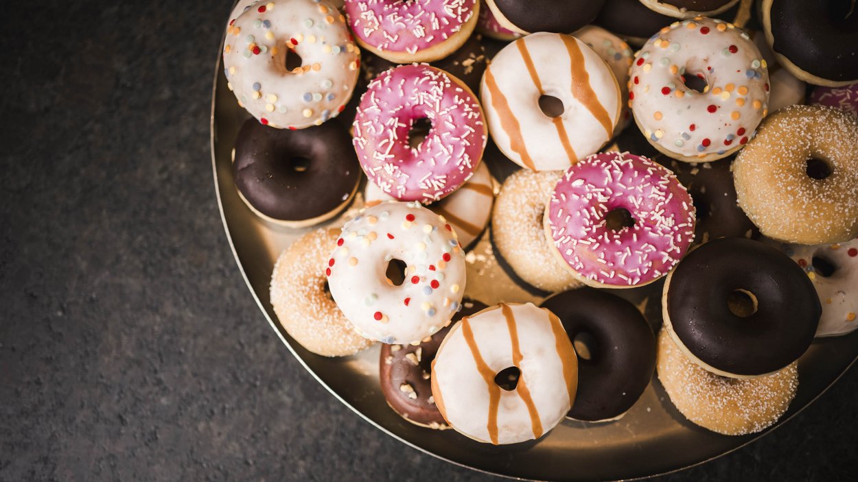 Family-friendly hotel in South Tyrol Assorted colorful donuts on a round tray