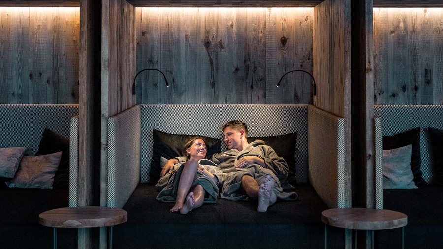 Wellness hotel in South Tyrol | Dolomites Couple relaxing together in a modern cozy lounge area at a spa