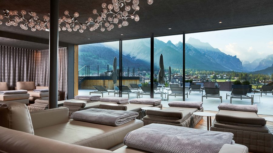 Excelsior: your hotel with whirlpool room in the Dolomites Modern lounge with comfortable seating and view of terrace and mountains