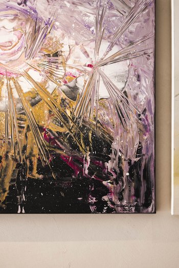 Art in the design hotel in South Tyrol Two abstract paintings on a wall with vibrant colors and dynamic patterns