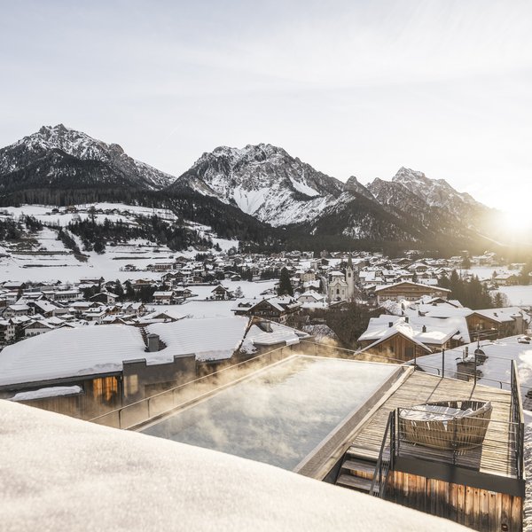 More than a hotel: Excelsior Sunrise over snowy mountain village with heated outdoor pool