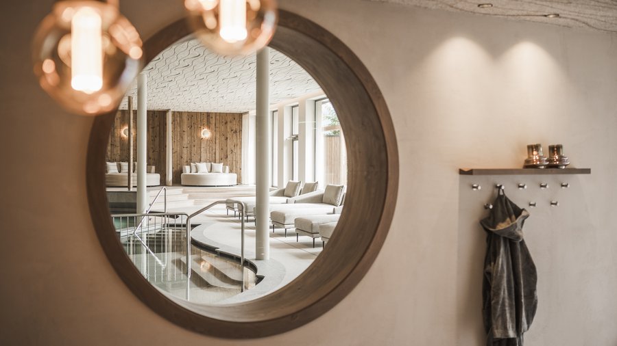South Tyrol: wellness holiday à la Excelsior Mirror reflecting stylish spa area with pool and comfortable seating