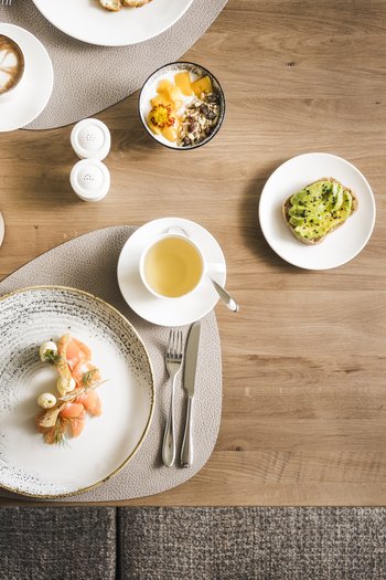 More than a hotel: Excelsior Various breakfast dishes and drinks on a wooden table