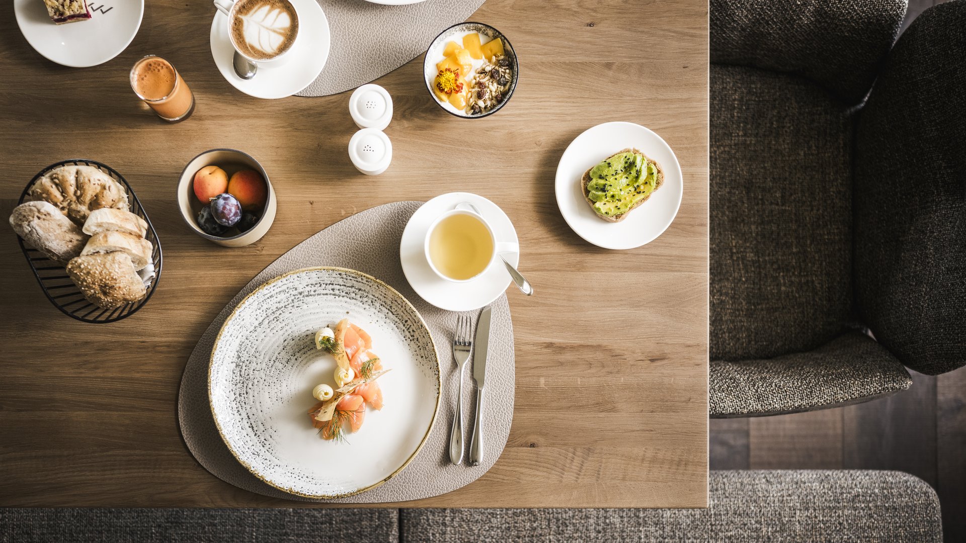 Wellness hotel in the Dolomites Various breakfast dishes and drinks on a wooden table