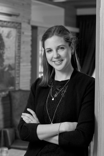 Your hotel in St. Vigil in Enneberg!! Young woman with crossed arms smiling in a cozy room